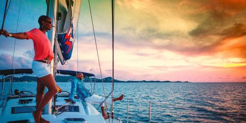 Woman on yacht gazing at sunset